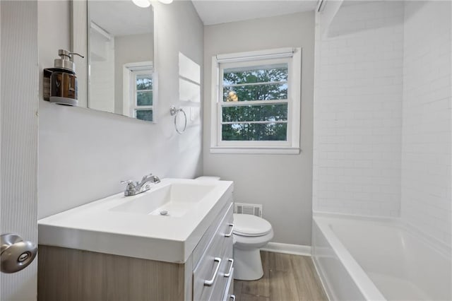 full bathroom featuring hardwood / wood-style flooring, vanity, shower / bathtub combination, and toilet