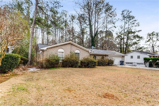 view of front of home with a garage and a front yard