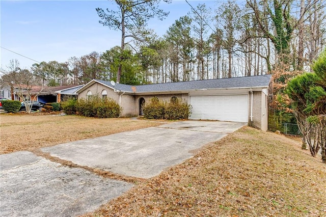 ranch-style home featuring a garage and a front yard