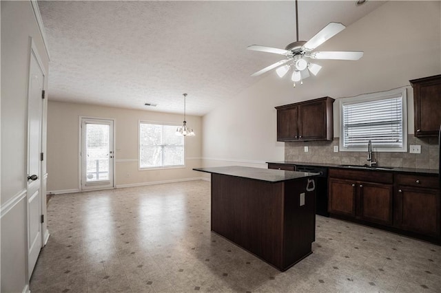 kitchen featuring backsplash, a center island, lofted ceiling, dark brown cabinetry, and sink