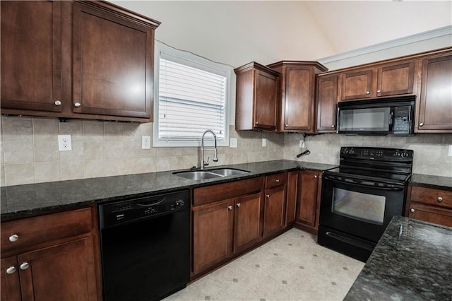 kitchen featuring black appliances, lofted ceiling, dark stone counters, sink, and dark brown cabinets