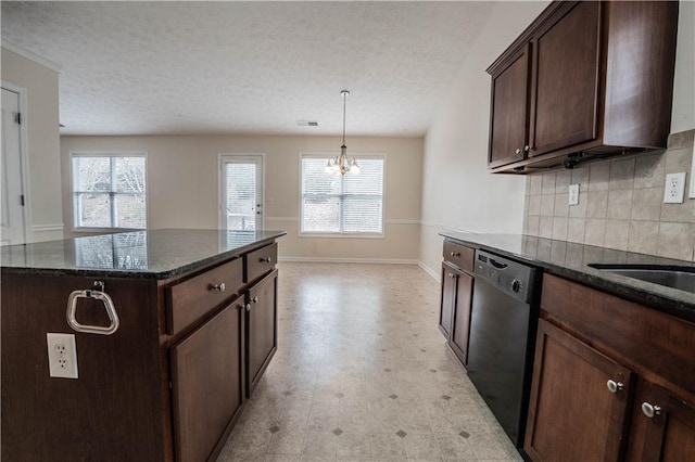 kitchen featuring black dishwasher, dark brown cabinets, dark stone counters, and a center island