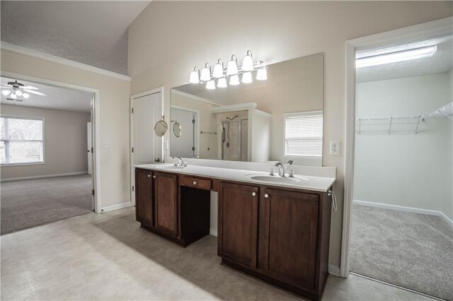 bathroom with ceiling fan, lofted ceiling, and vanity