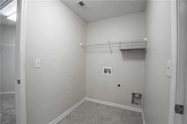 laundry area featuring a textured ceiling, hookup for a washing machine, and hookup for an electric dryer