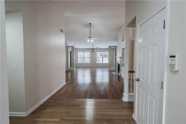 hallway featuring dark hardwood / wood-style flooring and lofted ceiling