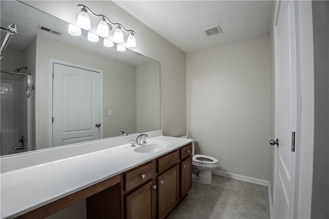 bathroom featuring toilet, walk in shower, and vanity