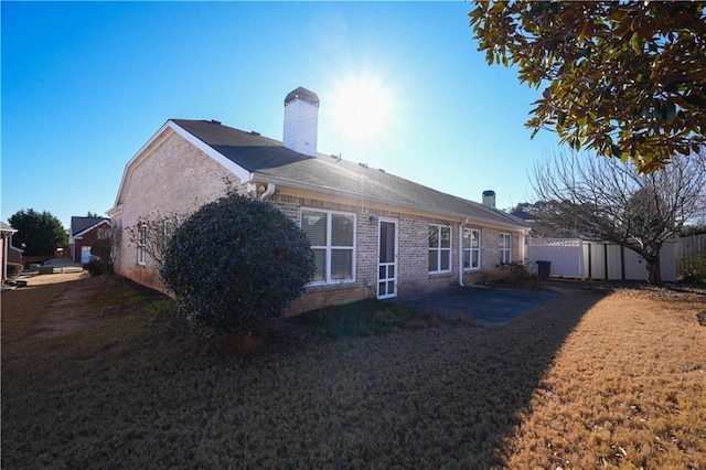 view of home's exterior featuring a yard and a patio