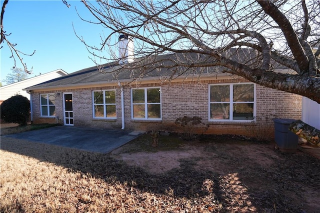 back of property with a patio