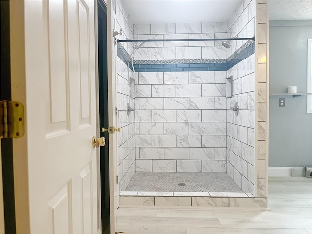 bathroom with tiled shower