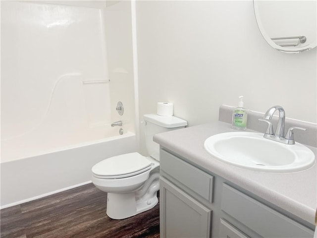 full bathroom featuring hardwood / wood-style flooring, vanity, toilet, and shower / bath combination