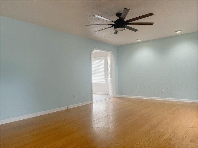 spare room with light hardwood / wood-style floors and ceiling fan