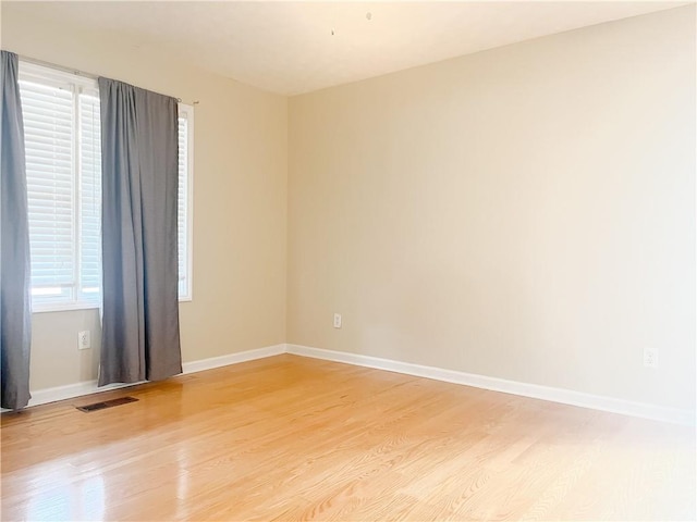 spare room with wood-type flooring