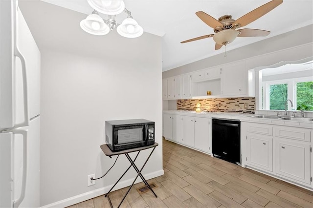 kitchen with black appliances, a sink, open shelves, and white cabinets
