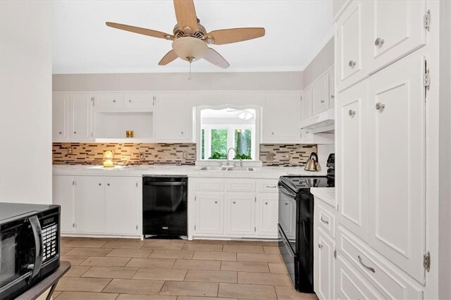 kitchen featuring black appliances, a sink, light countertops, and backsplash