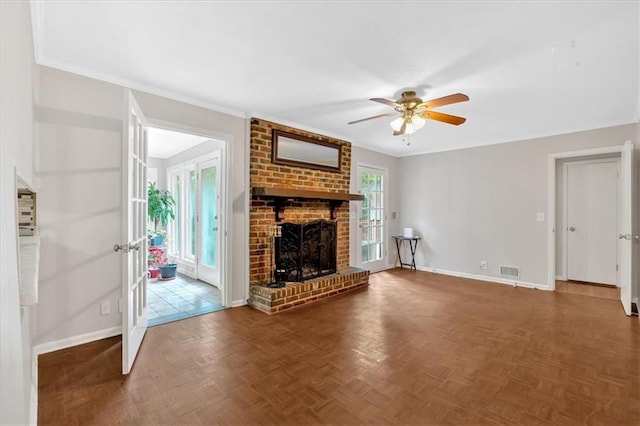 unfurnished living room with baseboards, a ceiling fan, a fireplace, and crown molding