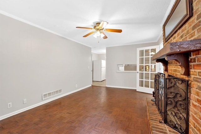 unfurnished living room with a ceiling fan, baseboards, ornamental molding, and a brick fireplace