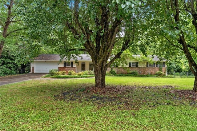 ranch-style home featuring a garage, brick siding, and driveway