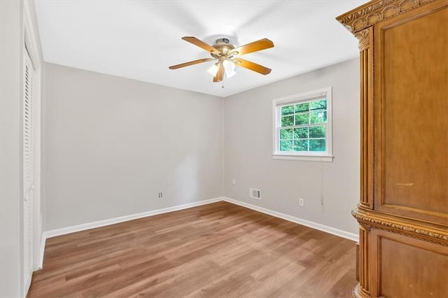 unfurnished bedroom with light wood finished floors, baseboards, and a ceiling fan