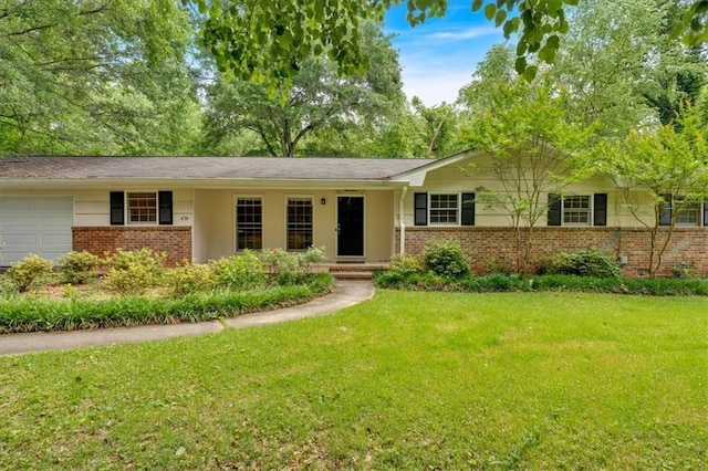ranch-style house with brick siding, a front yard, and an attached garage