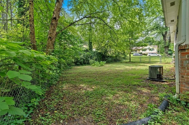view of yard with fence and cooling unit