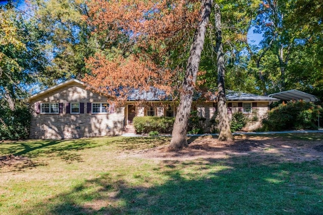 ranch-style house with a front yard and a carport