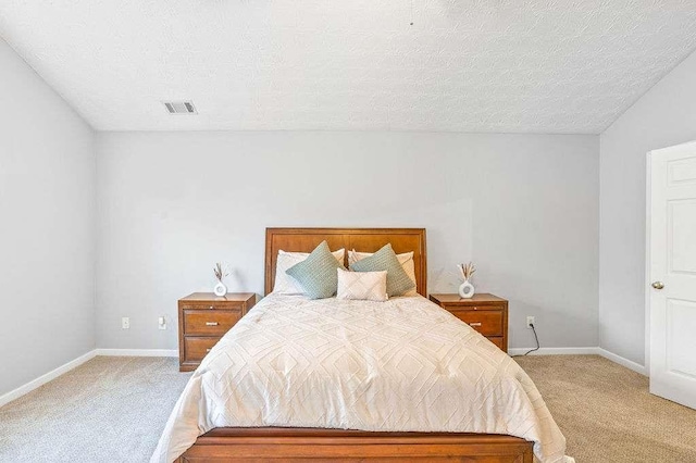 carpeted bedroom featuring a textured ceiling