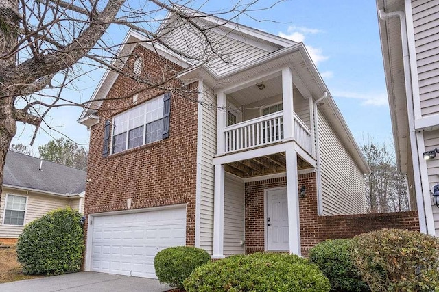 view of front of home featuring a garage and a balcony