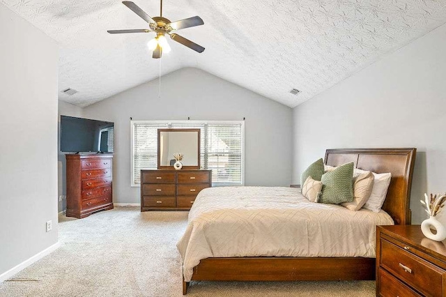 bedroom featuring ceiling fan, lofted ceiling, light carpet, and a textured ceiling