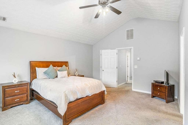 carpeted bedroom featuring ceiling fan, lofted ceiling, and a textured ceiling