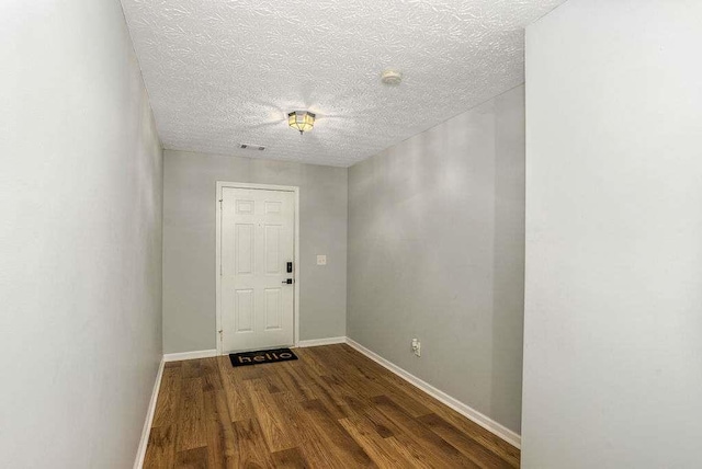 interior space featuring hardwood / wood-style floors and a textured ceiling