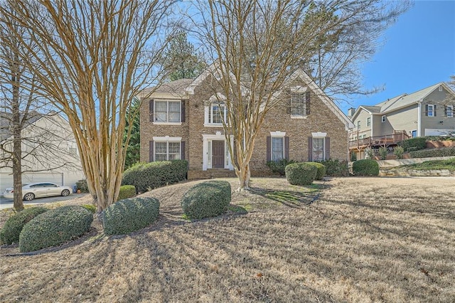 view of front of home with a front yard and brick siding