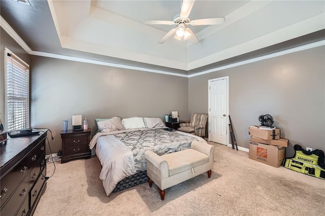 bedroom featuring a raised ceiling, light colored carpet, and crown molding