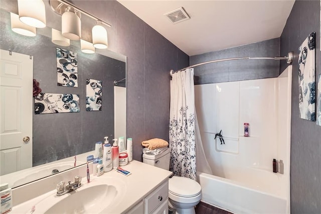 full bath with shower / bath combo, visible vents, vanity, and toilet