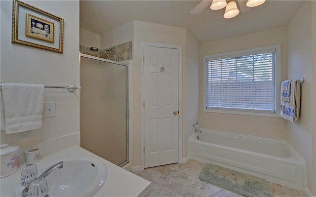 bathroom featuring tile patterned floors, a shower with door, vanity, a textured ceiling, and ceiling fan
