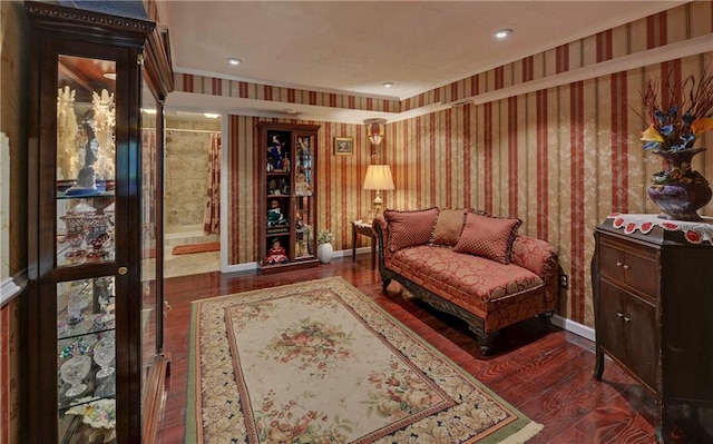 living area with dark hardwood / wood-style floors and crown molding