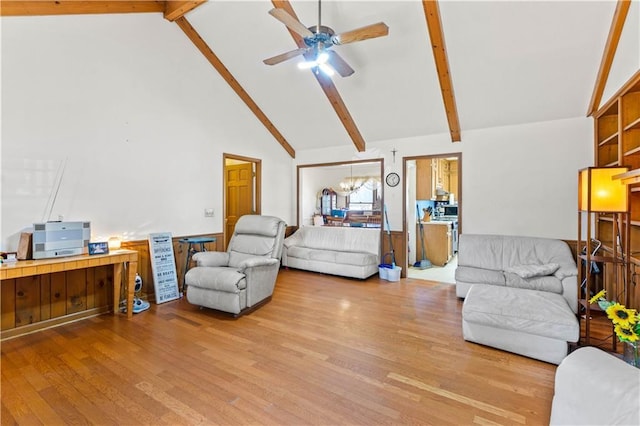 living room featuring beamed ceiling, high vaulted ceiling, ceiling fan with notable chandelier, and light hardwood / wood-style floors