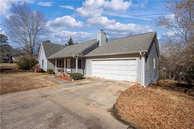 ranch-style house featuring a garage and covered porch