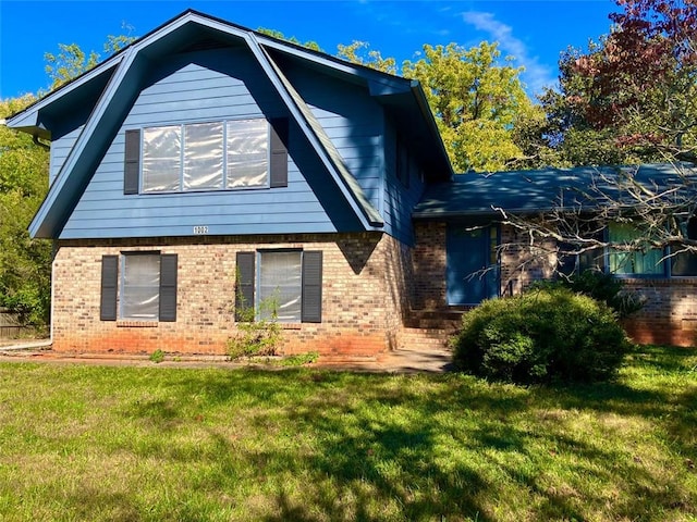 rear view of house featuring a lawn