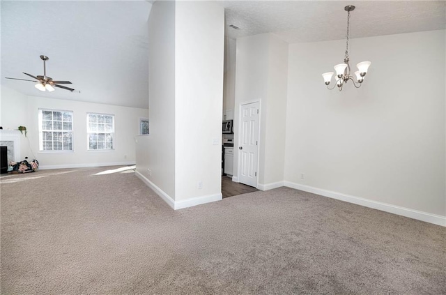 unfurnished living room with dark colored carpet, ceiling fan with notable chandelier, and lofted ceiling