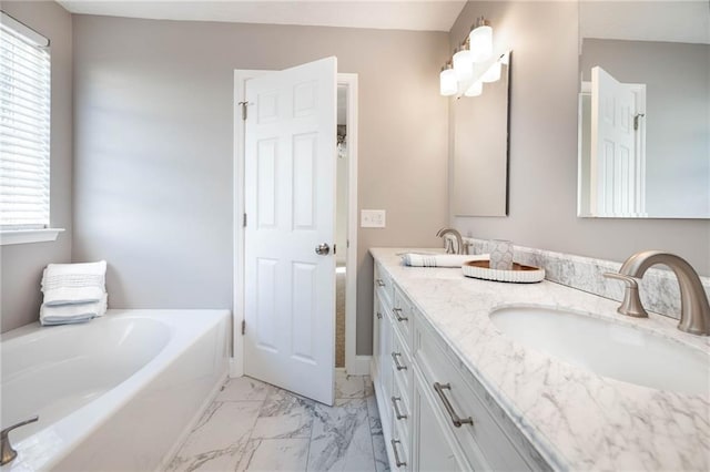 bathroom with vanity, a tub to relax in, and plenty of natural light