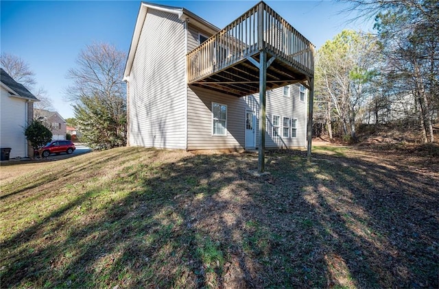 view of property exterior featuring a wooden deck and a yard