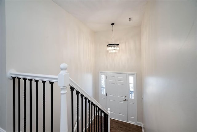 foyer featuring a notable chandelier and dark hardwood / wood-style floors