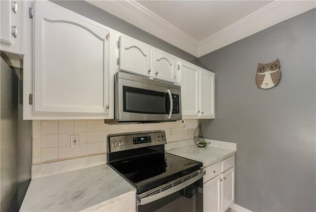 2700 Pine Tree Rd NE Unit 1013, Atlanta, GA 30324 - kitchen featuring stainless steel appliances, ornamental molding, white cabinetry, light countertops, and decorative backsplash