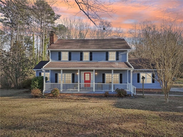 view of front of property featuring a lawn and covered porch