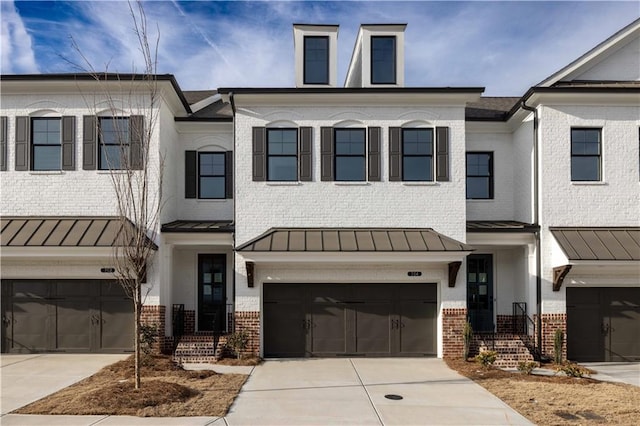 816 Dodd Trl S Unit 172, Buford, GA 30518 - multi unit property with a standing seam roof, brick siding, an attached garage, and driveway