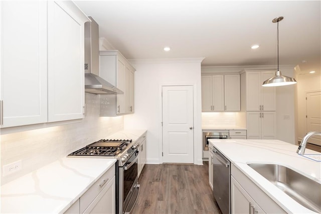 816 Dodd Trl S Unit 172, Buford, GA 30518 - kitchen featuring stainless steel appliances, wall chimney exhaust hood, a sink, tasteful backsplash, and recessed lighting