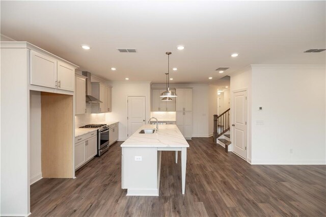 816 Dodd Trl S Unit 172, Buford, GA 30518 - kitchen featuring stainless steel gas range, wall chimney range hood, tasteful backsplash, a sink, and an island with sink