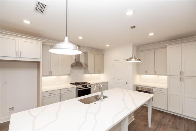 816 Dodd Trl S Unit 172, Buford, GA 30518 - kitchen with a sink, stainless steel gas range oven, wall chimney exhaust hood, tasteful backsplash, and an island with sink