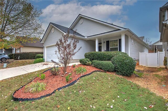 view of front of house featuring a garage and a front yard