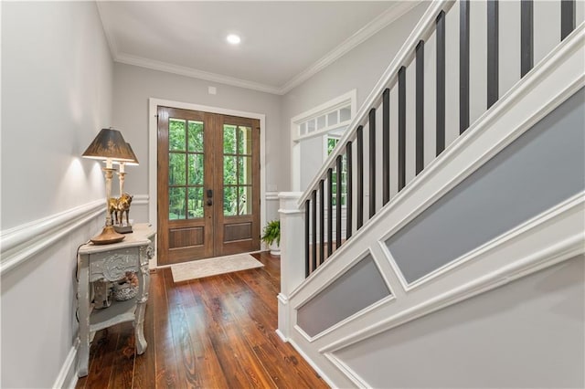 entrance foyer featuring dark hardwood / wood-style flooring, crown molding, and french doors